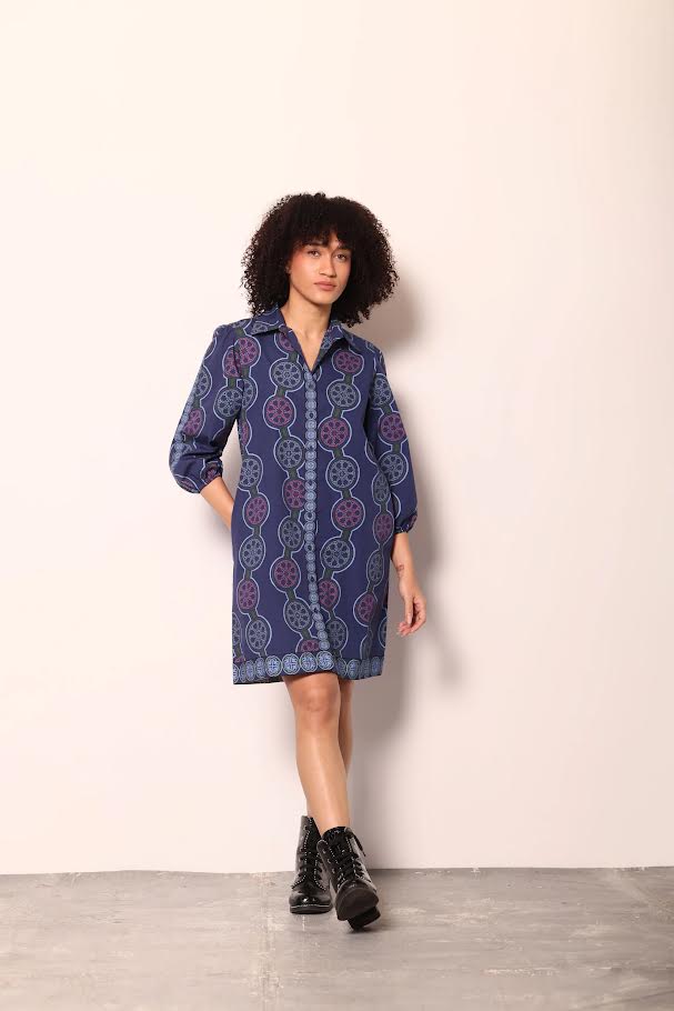 Navy blue shirt dress with a geometric pattern in purple and light blue, featuring a collared neckline and 3/4 sleeves.