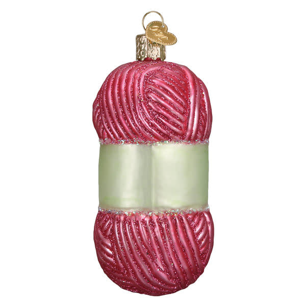 Hand-knitted yarn ornament in cream with a textured ribbed pattern.