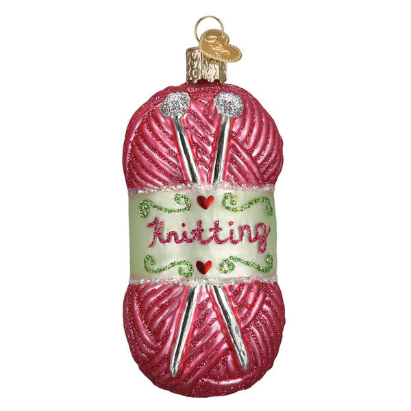 Hand-knitted yarn ornament in natural beige with a textured ribbed pattern.