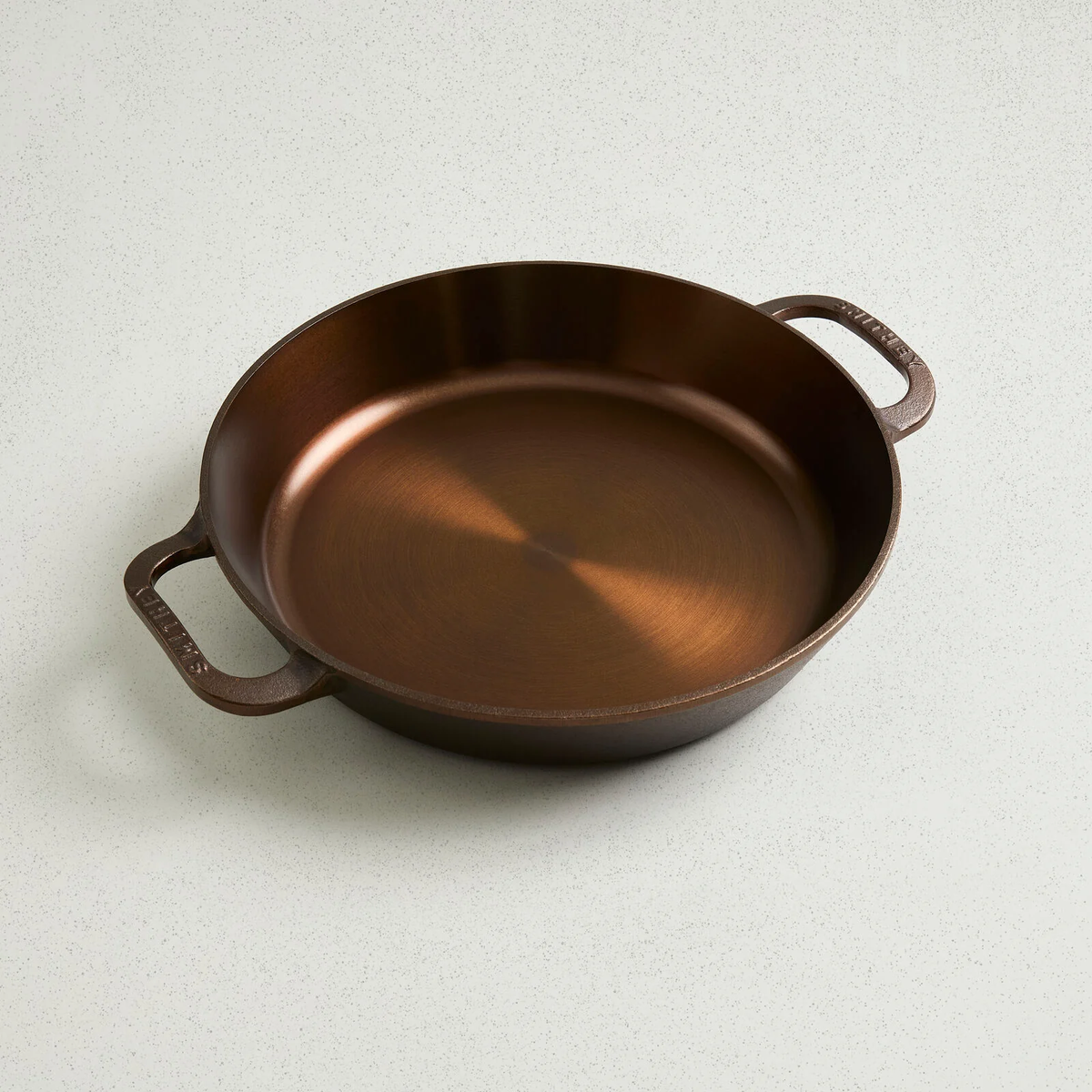 No. 12 Dual Handle Skillet with a polished copper-colored interior and two ergonomic side handles.