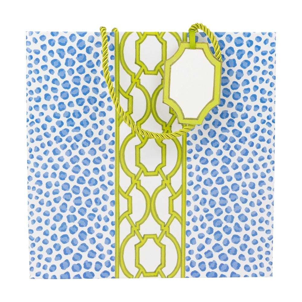 Medium square gift bag with blue and green spotted knot pattern on durable paper.