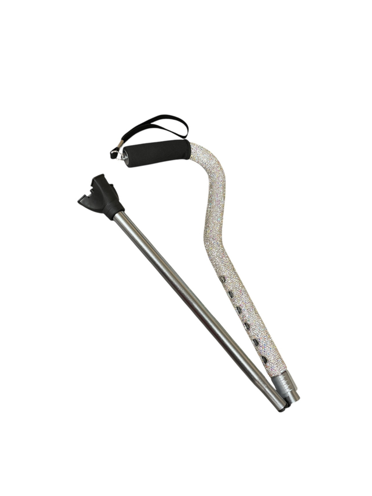 Adjustable silver rhinestone walking cane with a curved black foam handle and wrist strap.