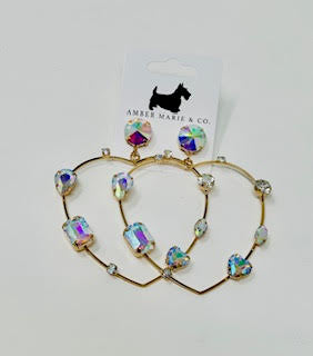 Heart-shaped earrings featuring clear crystals set in a silver-tone metal frame.