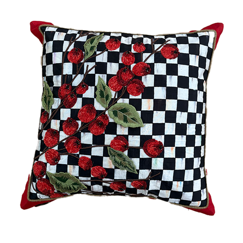 Square black and white checkered pillow with embroidered red holly berries and green leaves.