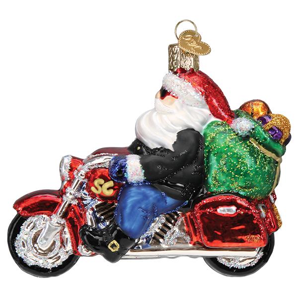 Biker Santa glass ornament riding a red motorcycle with a green gift bag on the back.