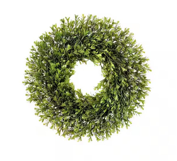 Spring-themed plastic boxwood wreath with green foliage arranged in a circular silhouette.