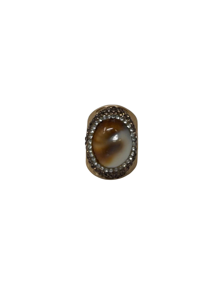 Queen of Sheba fashion ring featuring an oval brown and white stone surrounded by small crystals.