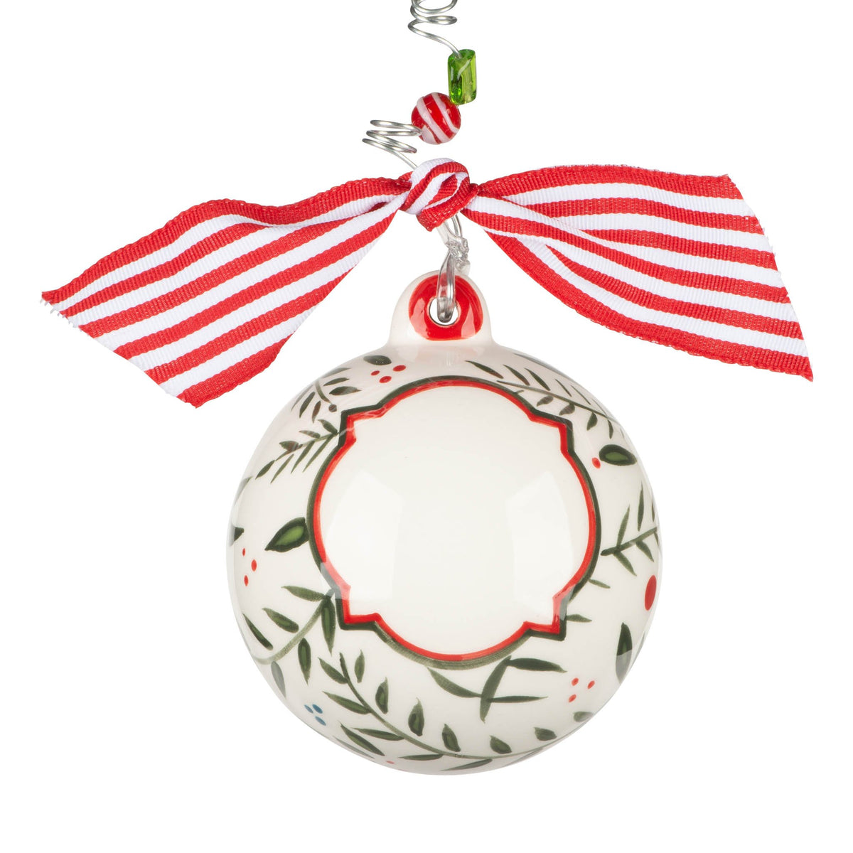 Hand-painted ceramic Christmas holly ornament with green leaves and red berries on a white background.