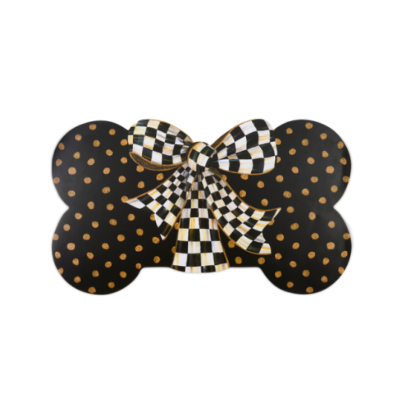Bone-shaped black puppy placemat with gold polka dots and a black and white checkered bow.