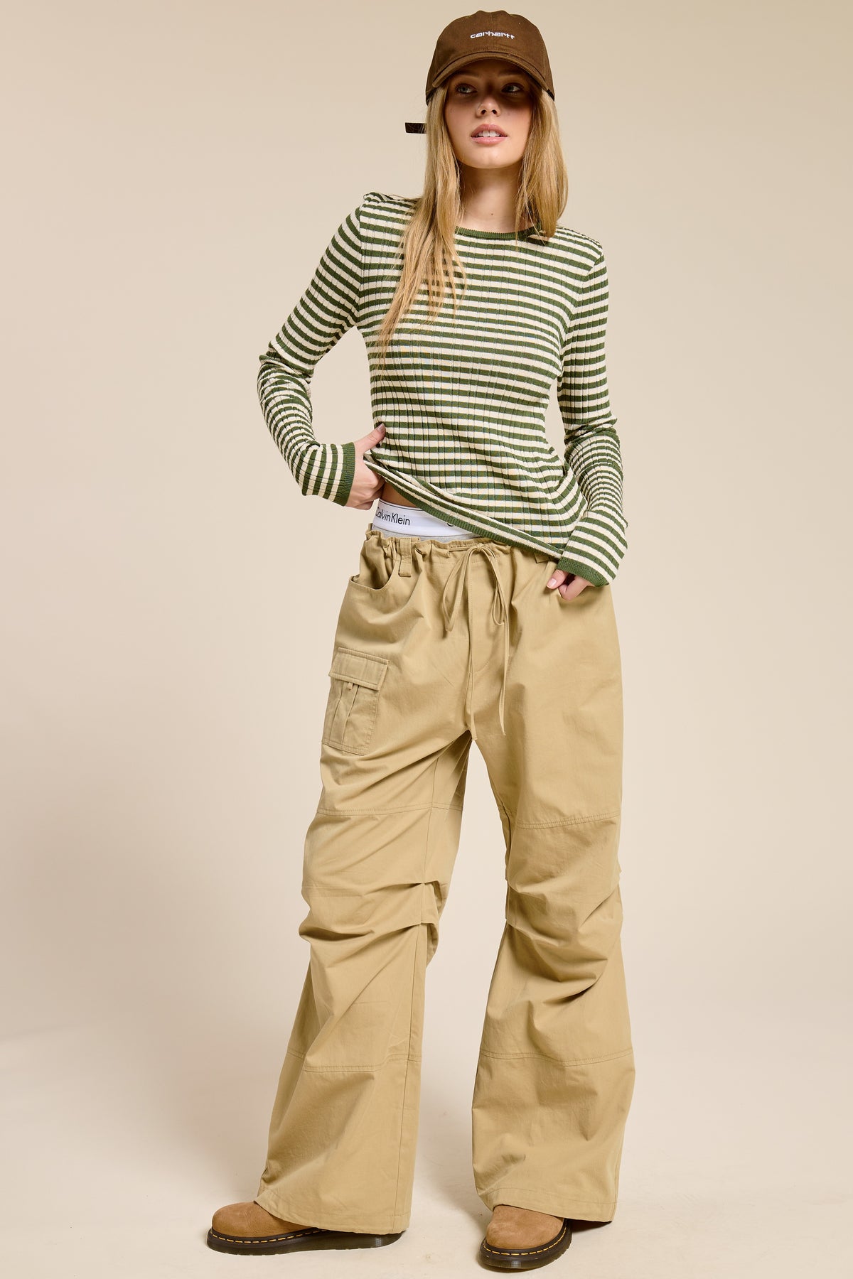 Ariah ribbed knit long-sleeve top with bold horizontal stripes in warm neutral tones and a classic crew neckline.