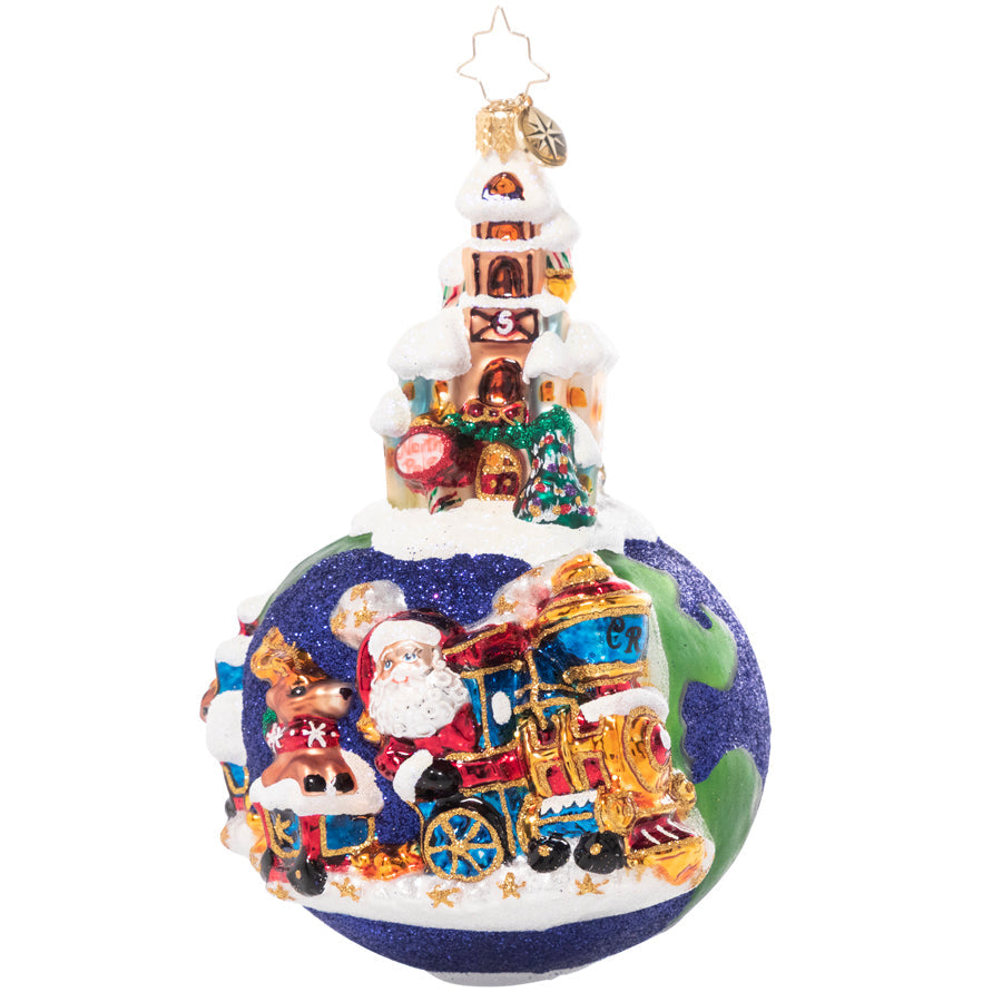 Glass Christmas ornament of Santa and a reindeer on a train traveling around a glittery globe.