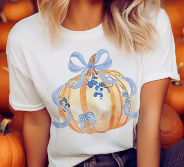 Cotton bow tie in fall pumpkin orange with blue floral print on a white background.