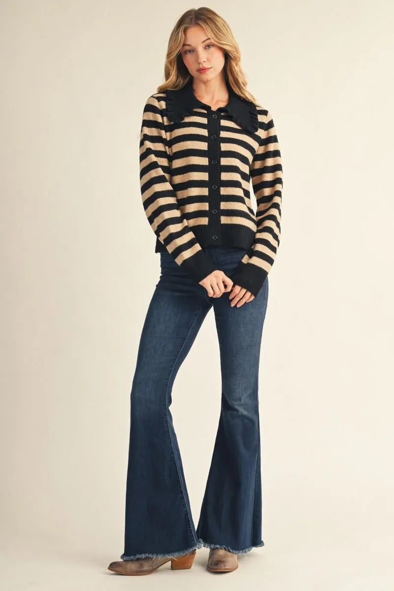 Woman wearing a Mika long sleeve button-down striped sweater cardigan with a ruffled collar.