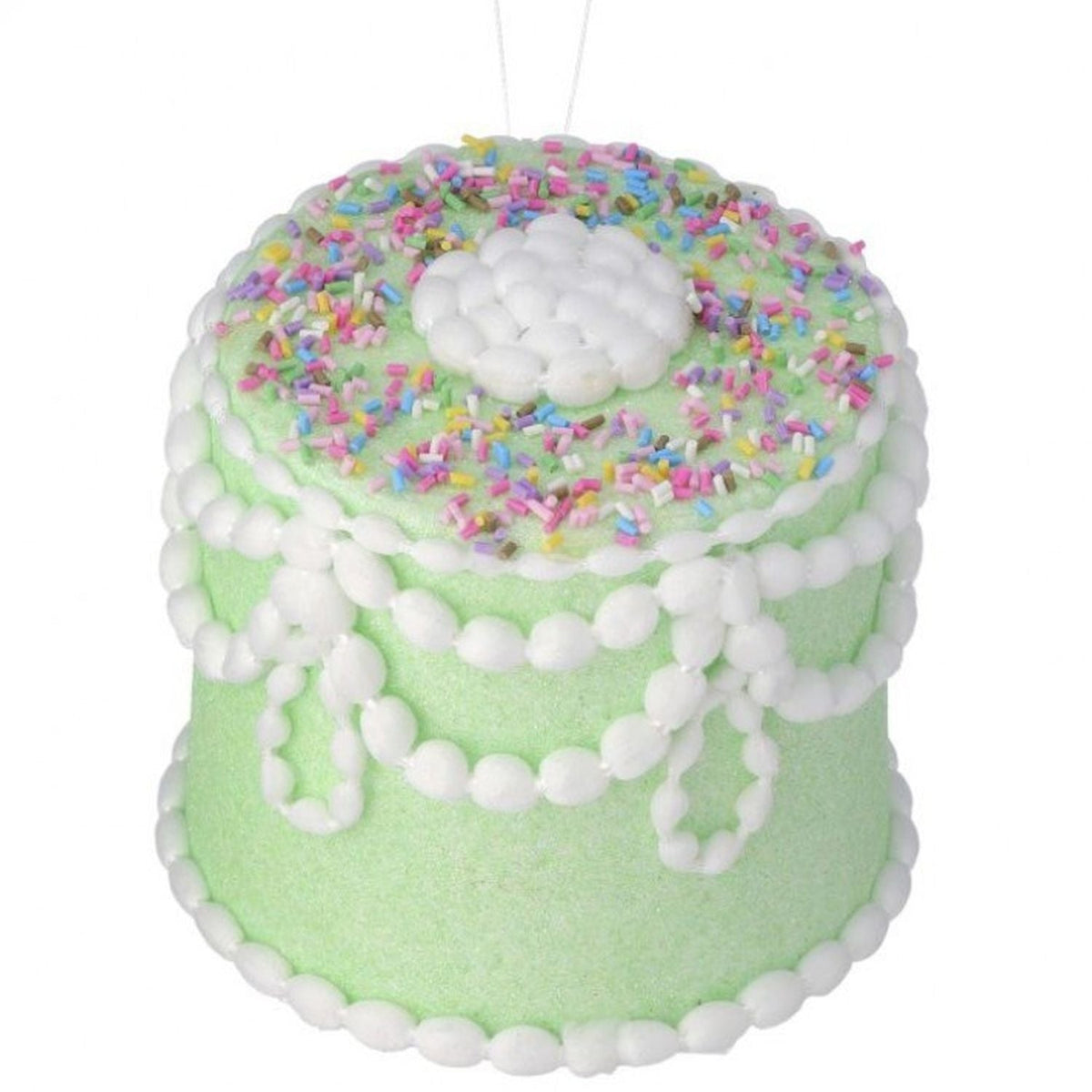 Five-inch pastel candy decorated cake ornament with colorful sprinkles on a white silhouette.