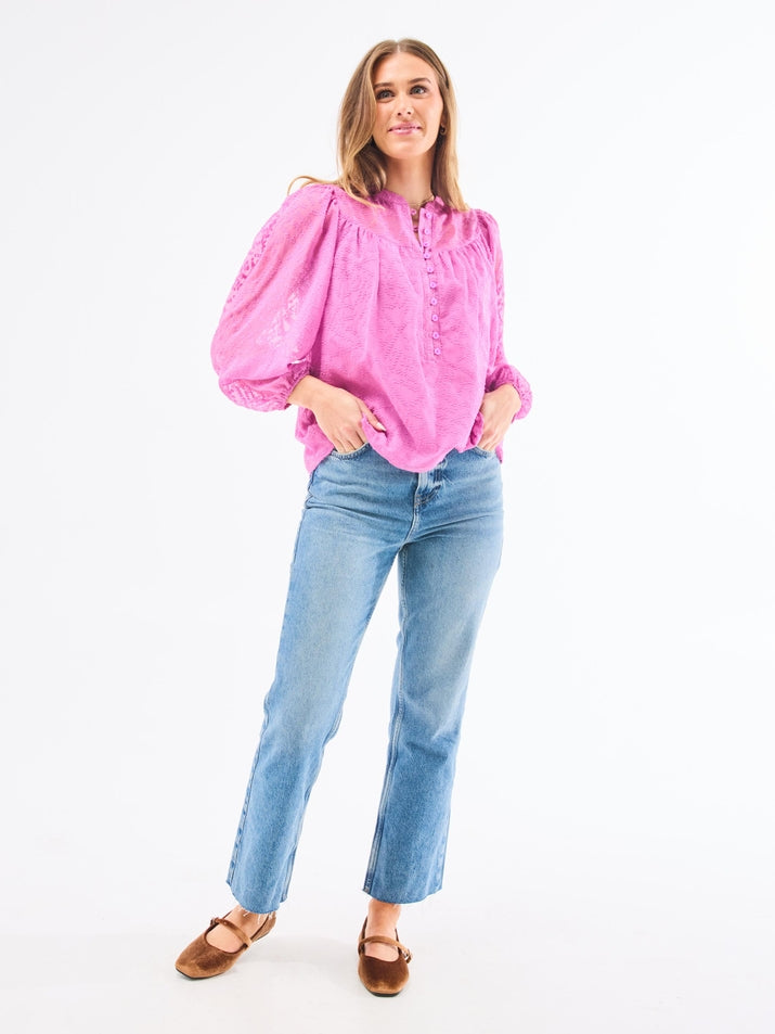 Brianna Top in clip dot chiffon polyester with lined bodice, button-loop placket closure, and elastic cuffs.