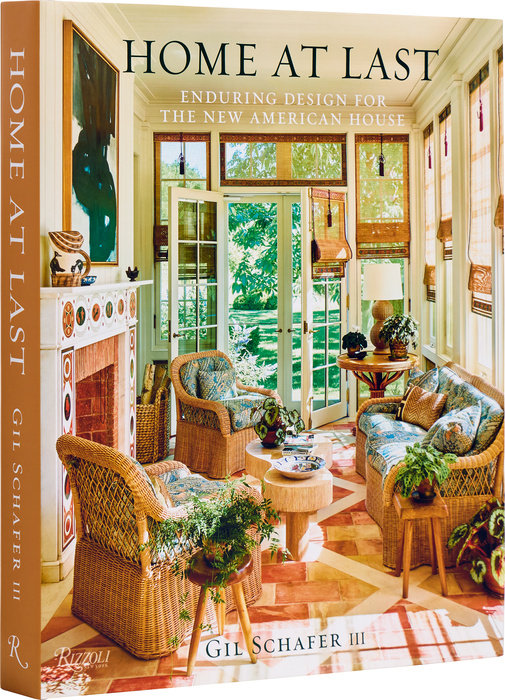 Book cover of Home At Last by Gil Schafer III, featuring a sunroom with wicker furniture.
