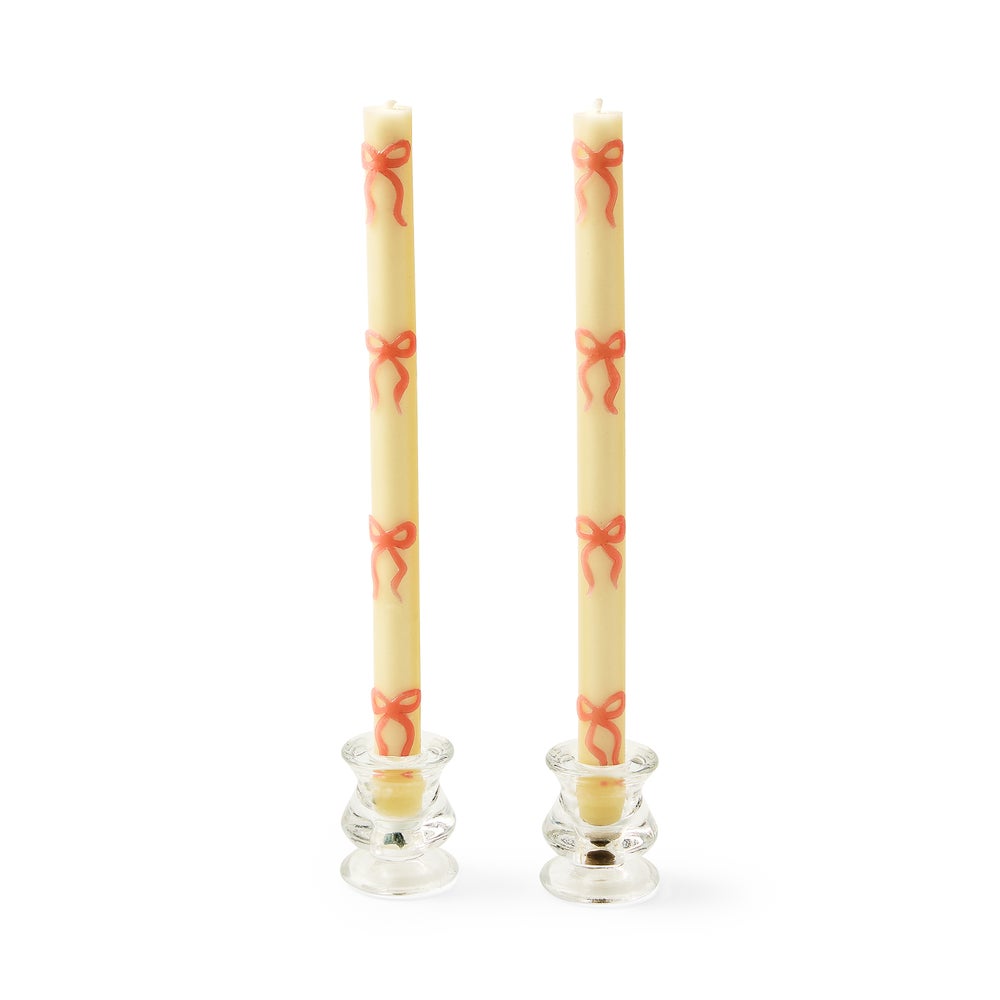 Two beeswax-blend pink candles with ribbon bow patterns in a boxed set.
