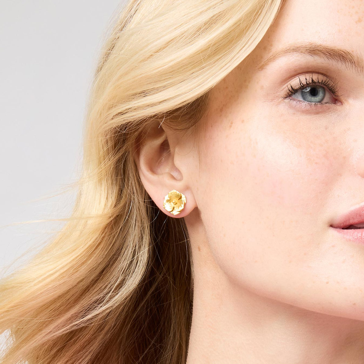 Small gold-plated stud earring with a floral bloom design.