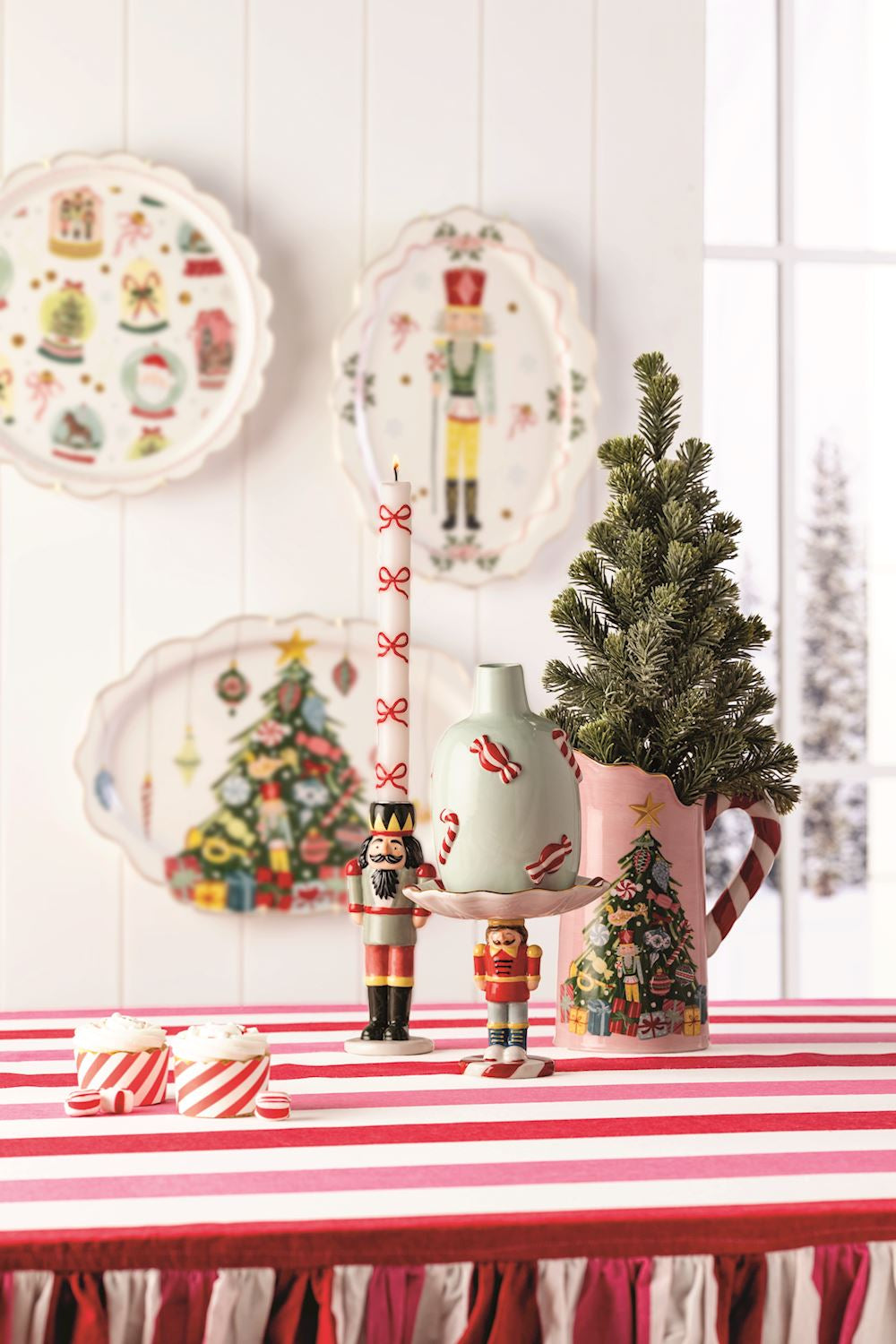 Oval dolomite Nutcracker Small Platter with a scalloped edge hanging on a white paneled wall.