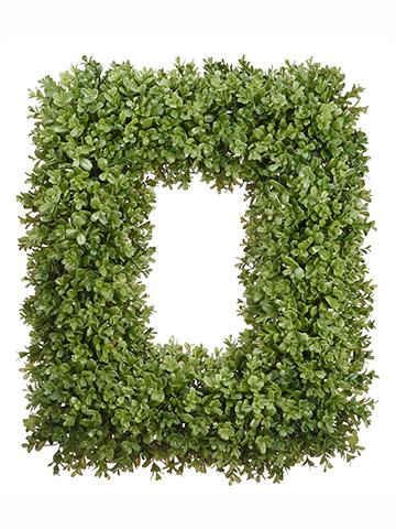 Green boxwood wreath with realistic foliage on a round wooden frame.