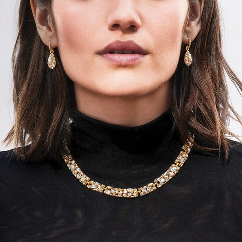 Woman wearing Trust Your Journey Golden French Wire Earrings and a matching crystal necklace.