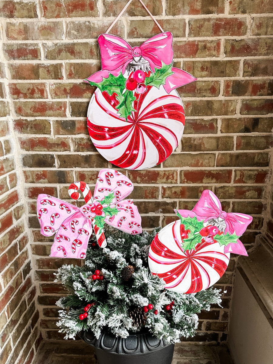Beck's Vintage candy cane striped PVC door hanger with a ball silhouette.