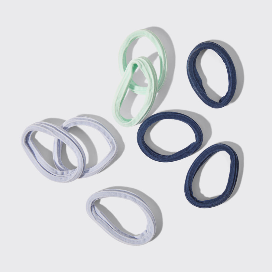 Set of 8 seamless hair elastics in garden-inspired shades of mint green, light blue, and navy.