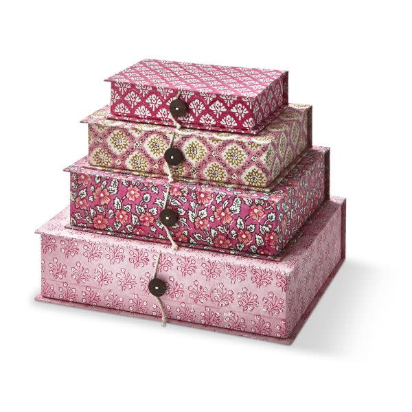 Stack of four Emma Handmade Paper Keepsake Boxes in pink floral and damask patterns, tied with twine and buttons.