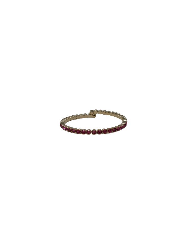 Gold cuff ring featuring a row of small, round pink crystals.