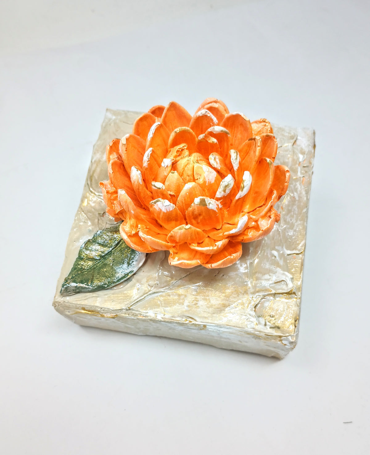 4x4 inch square clay artwork featuring a mum flower with textured petals in earthy tones.