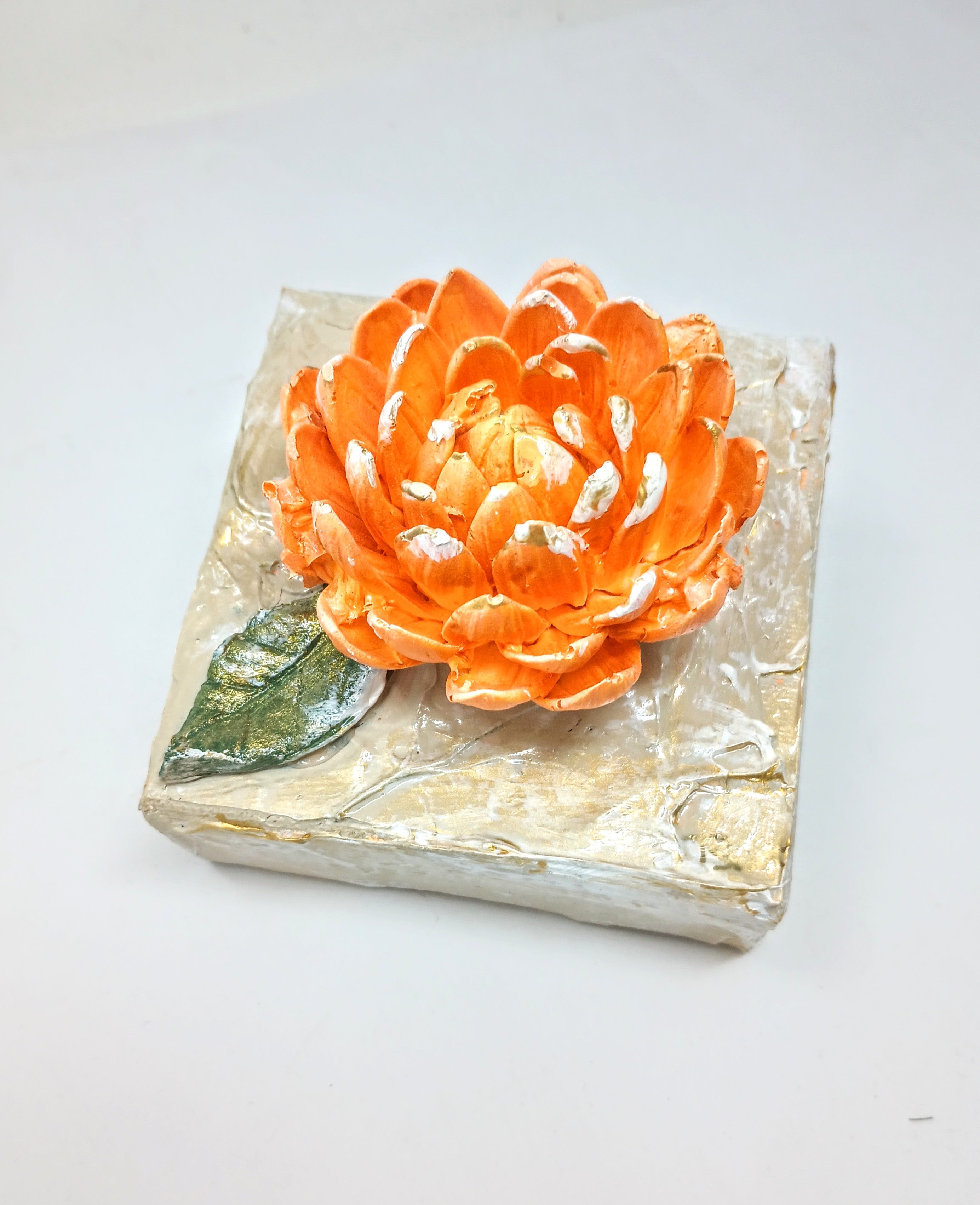 4x4 inch square clay artwork featuring a mum flower with textured petals in earthy tones.
