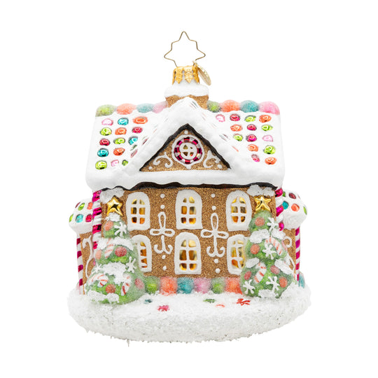 Sweet Treat House gingerbread ornament with snowy icing, candy accents, and two frosted trees.