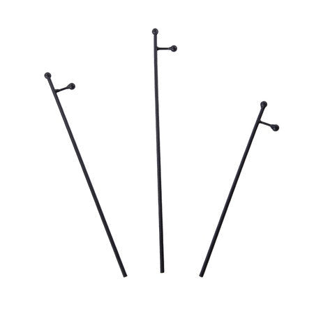 Three slender black metal display poles with rustic stakes in varying heights.