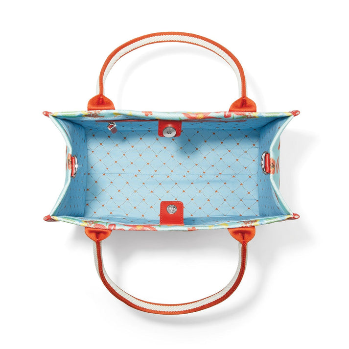 Interior view of the Painterly Garden Canvas Carryall showing blue heart-patterned lining.