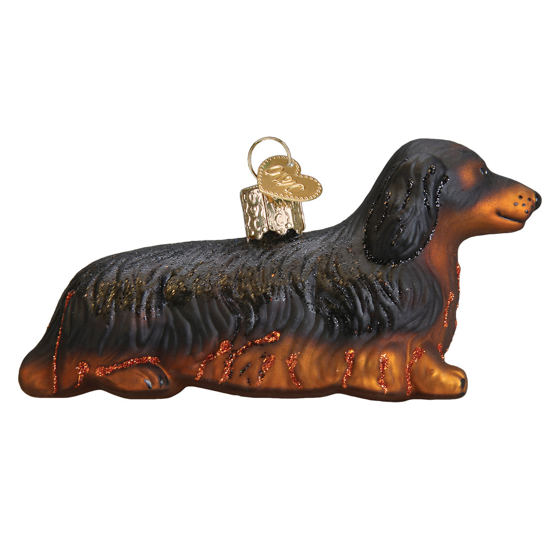 Long-haired Dachshund glass ornament with black and brown fur, glitter accents, and a gold heart tag