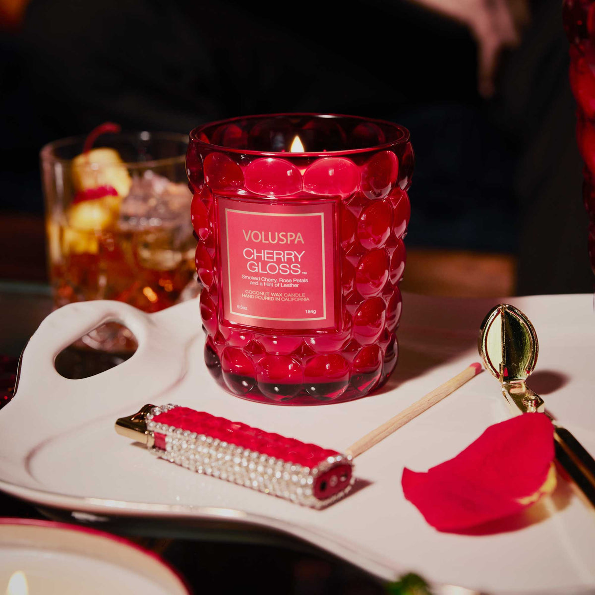 Cherry Gloss candle in a clear glass jar with a natural wick.