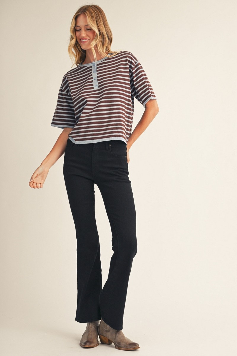 Woman wearing the Hannah Stripe Lightweight Sweater Top in brown and blue with black flare jeans.