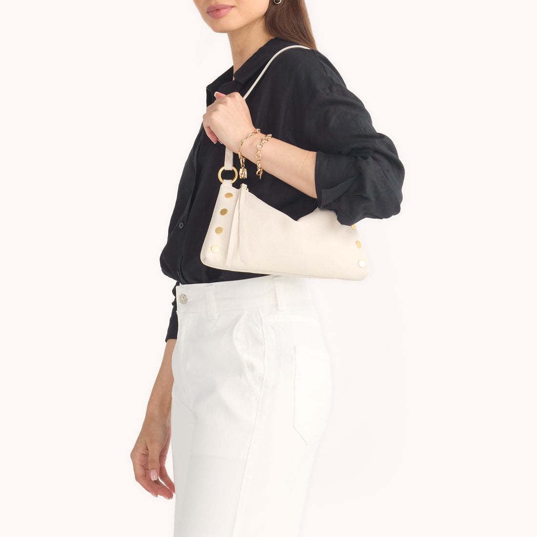 Side view of the Kyle bag in black leather with a detachable crossbody strap and short shoulder handle.