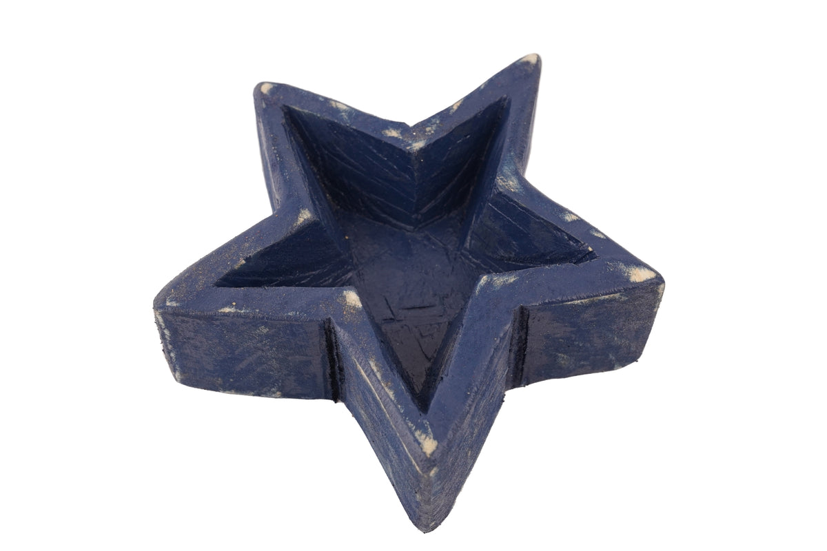 Star Dough Bowl Candle in a white ceramic bowl with a star-shaped wick holder.