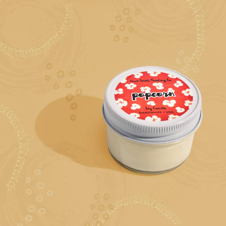 Pop Scents soy candle in a clear glass jar with a white wick.