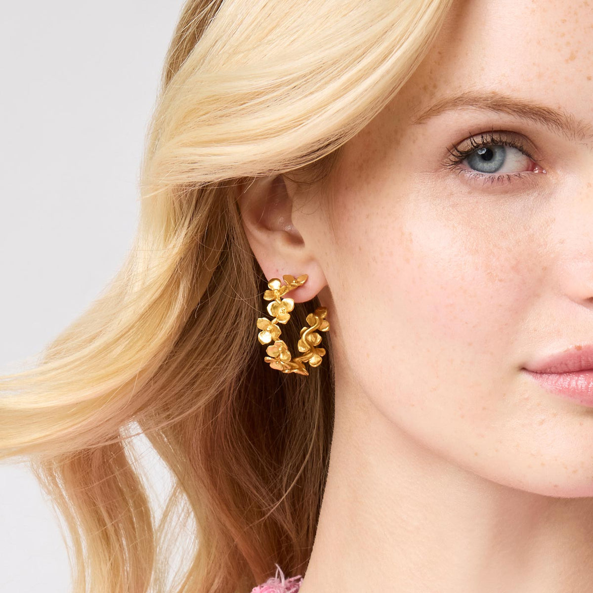 Medium size Bloom hoop earring with 24K gold plating on a pierced ear.