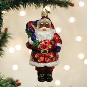 Jolly African American Santa glass ornament with a red star-patterned suit and a sack of gifts.