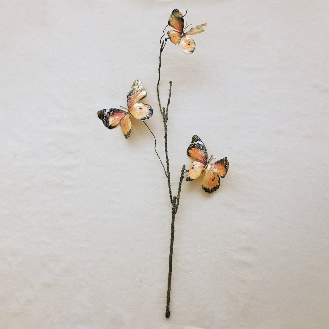 Faux butterfly stem featuring three brushed gold and orange butterflies on a textured brown branch.