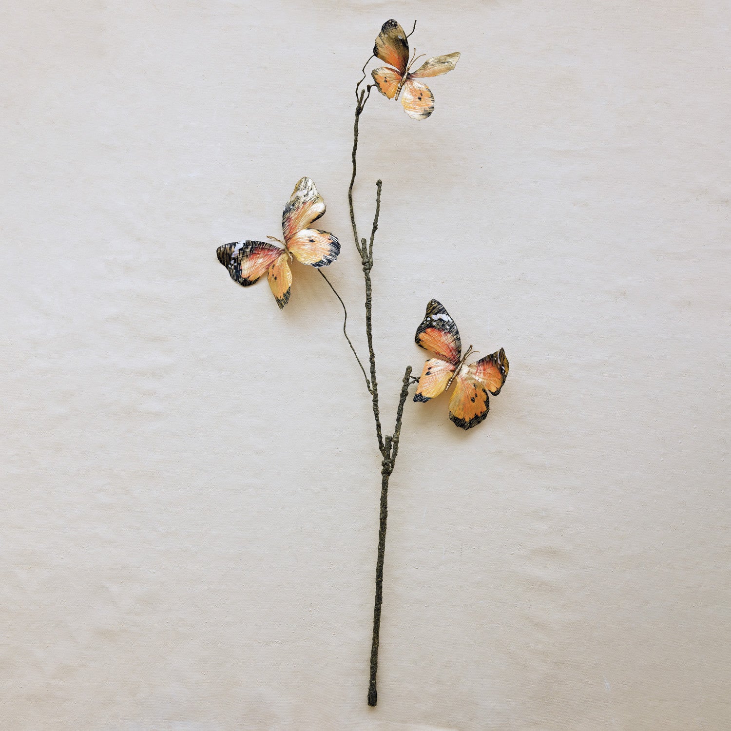 Faux butterfly stem featuring three brushed gold and orange butterflies on a textured brown branch.
