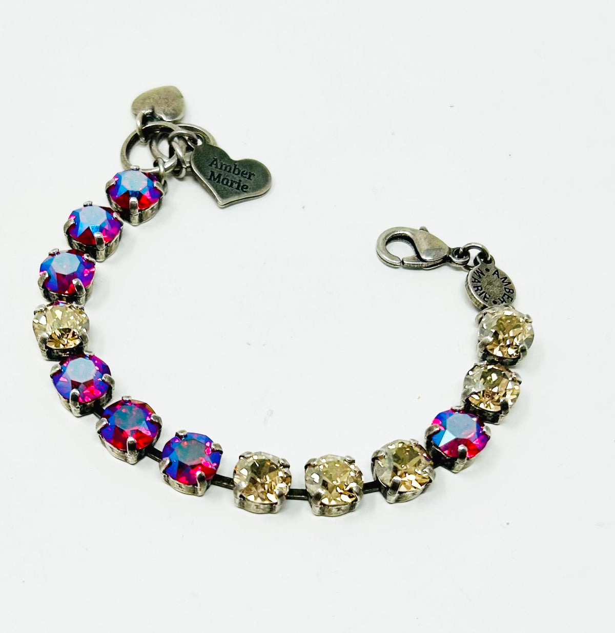 Silver-tone bracelet with alternating red/blue and champagne crystals, featuring a heart charm engraved 'Amber Marie'.