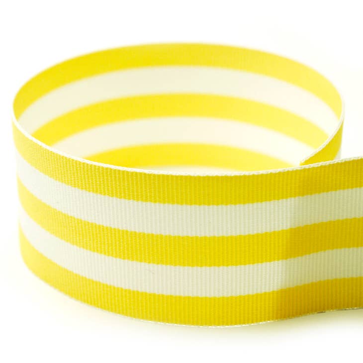 Spool of solid grosgrain ribbon in a neutral tone with a smooth texture.