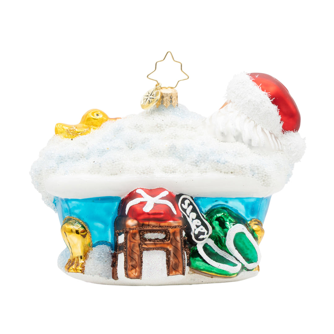 Santa Claus relaxing in a bubble bath ornament with a rubber duck and festive details.