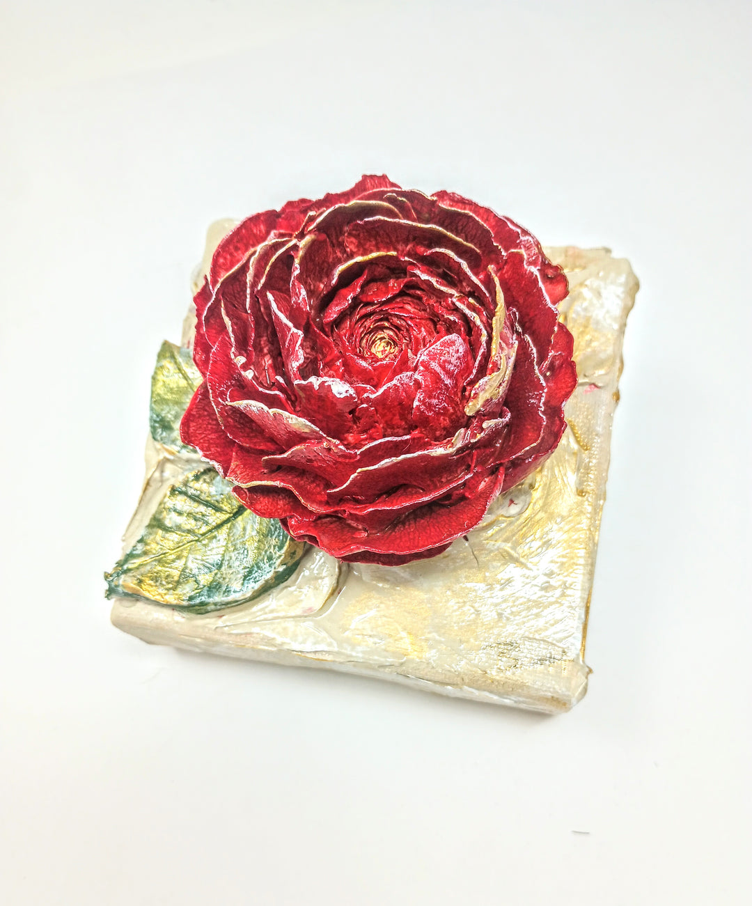 4x4 inch square clay artwork featuring a rose relief with textured petals in earthy terracotta tones.