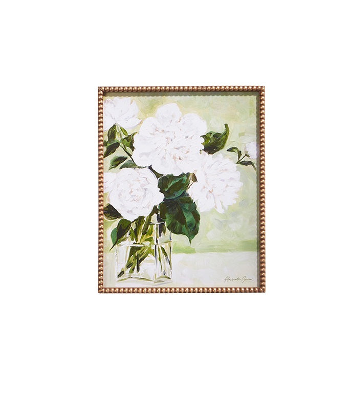 Framed print showing white flowers in a vase on wood with glass.
