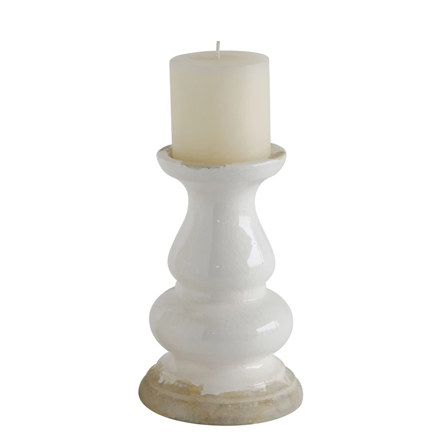 White round stoneware candle holder with a smooth matte finish designed to hold a three-inch pillar candle.